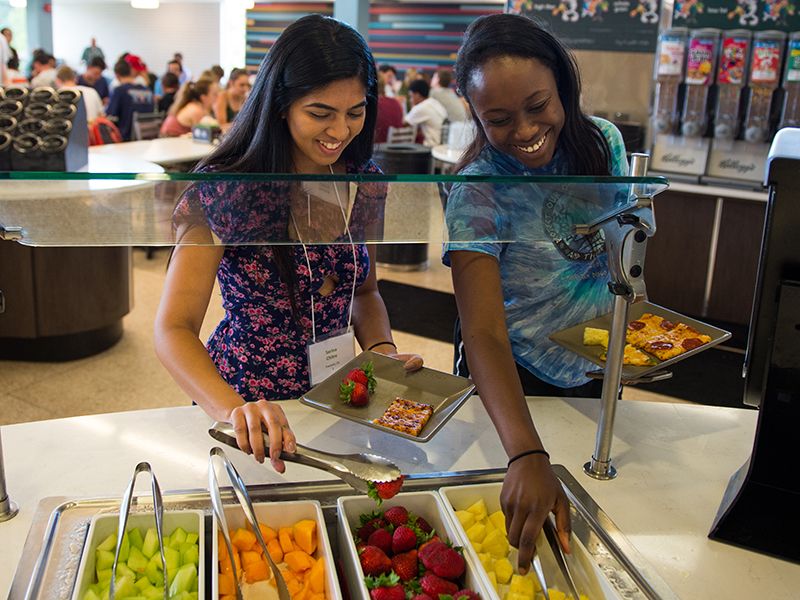 Students select from fresh fruit in the salad bar in Bruff Commons