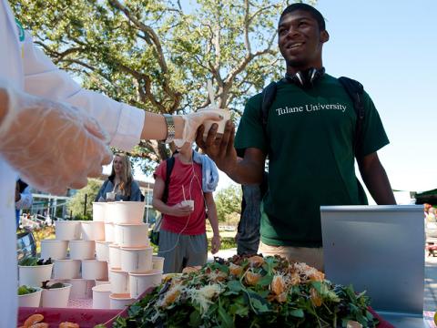 student at a table receiving food